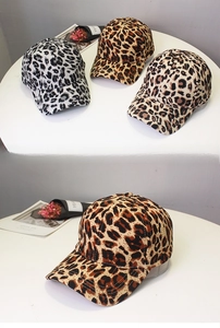 Detailed close-up showing leopard print patterns on high-quality baseball caps