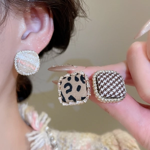 Detailed view of tweed and leopard print square studs with glittering rhinestone borders