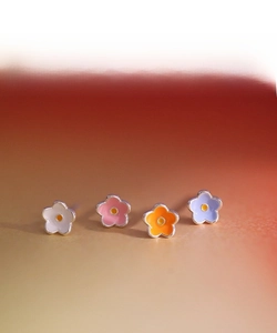 Macro shot of colorful enamel flower earrings in pink, orange, purple and white