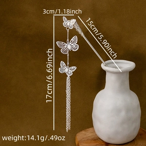 Close-up of silver hollow butterfly hair pin with long metal tassels for Hanfu hairstyle