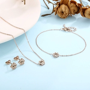 Rose gold stainless steel jewelry set featuring crystal cat paw necklace, bracelet, and studs