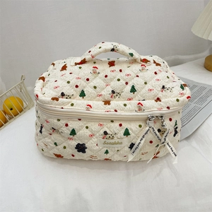 Quilted off-white cosmetic bag with festive Christmas prints and double zipper closure
