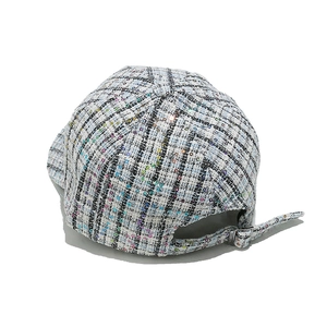 Detail of tweed baseball cap back with silver metal buckle and shimmering sequins
