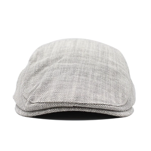 Detailed view of grey herringbone fabric texture and stitching on the newsboy flat cap