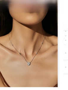 Close-up of S925 silver necklace with sparkling round diamond pendant on a model neck