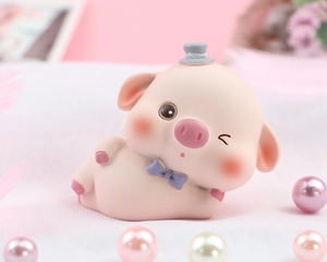 Macro view of a cute pink resin piglet with a grey hat and purple bow tie on pearls