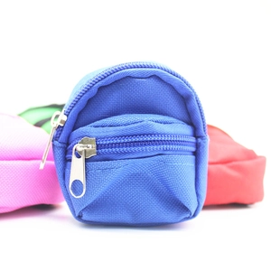 Macro detail of mini backpack coin purse with double zippers and blue canvas texture