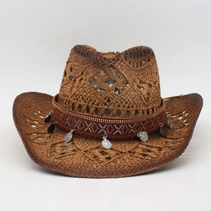 Detail of handmade straw cowboy hat with ethnic embroidery and silver coin pendants