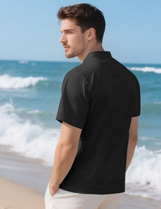 Detail of black breathable mesh polo shirt showing side view and beach lifestyle texture