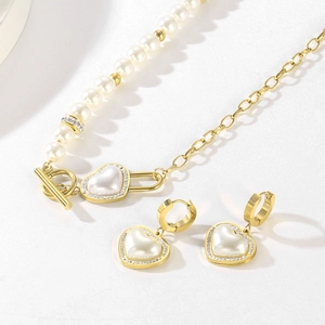Detail of heart pearl jewelry set with gold OT toggle necklace and crystal earrings