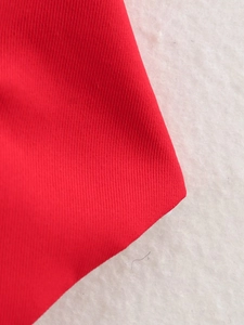 Detailed close-up of vibrant red textile fabric texture and premium weaving quality