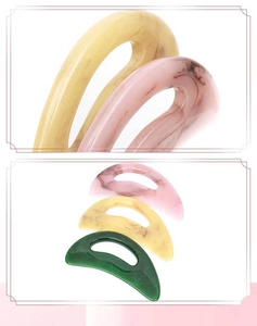 Macro detail of resin body scraping tools in pink, yellow, and green colors