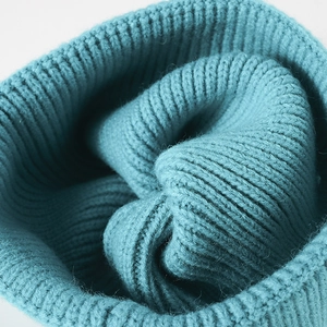 Classic ribbed knit beanie in teal green showing warm texture and stretchable wool blend fabric