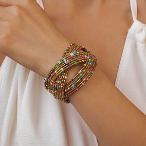 Macro detail of bohemian multilayered beaded cuff bracelet with colorful glass seed beads