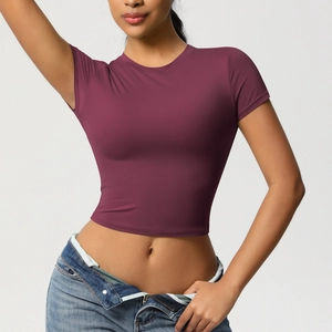 Detail of slim fit burgundy crop top yoga t-shirt made with quick-dry stretch fabric