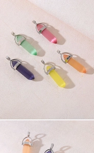 Close-up of hexagonal natural crystal pendants in various colors with metal clasps