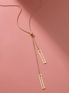 Detailed view of golden Y-shaped adjustable necklace with rectangular geometric pendants