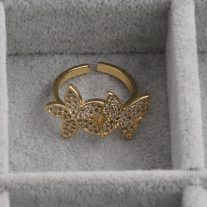Adjustable gold butterfly open ring with white cubic zirconia in a jewelry box