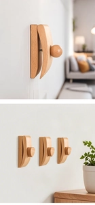Macro detail of wooden wall hooks with heart and sphere knobs on a white wall