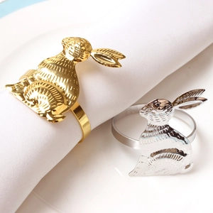 Detailed view of polished rabbit head napkin rings in gold and silver finish