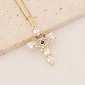 Detail of 18K gold plated cross pendant with colorful zircons and evil eye motif