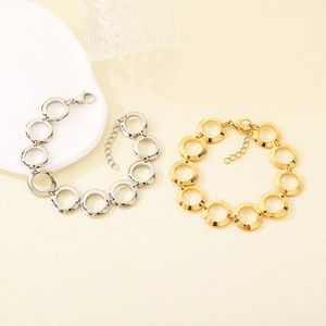 Detail of 18K gold plated and silver interlocking circle bracelets with lobster clasps