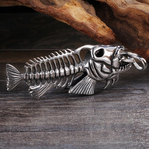 Macro shot of a punk style fish bone metal pendant necklace on rustic wood background