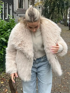 Chic beige faux fur jacket with lapel collar and fluffy texture on a stylish model