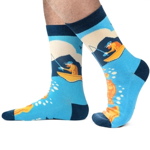 Detailed pattern of blue cotton crew socks featuring a fisherman scene with deep blue accents