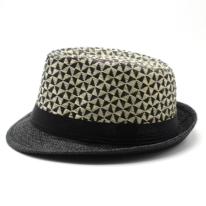 Detail of two-tone geometric weave pattern on a straw fedora hat for summer