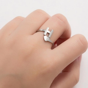 Minimalist silver H-letter heart open ring worn by model with polished metal finish