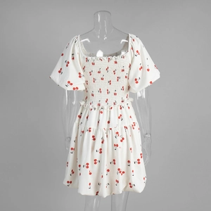 Detail of square neck dress with cherry print, smocked bodice, and puffed sleeves