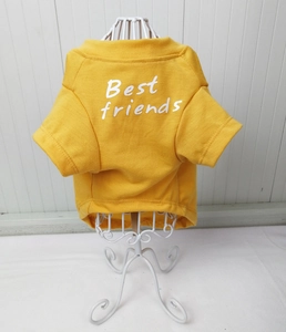 Close-up of yellow cotton dog T-shirt featuring white Best friends printed text detail