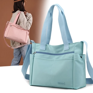 Close-up of lightweight waterproof nylon tote bags in light blue and pink with details