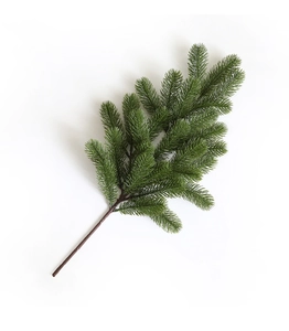 Close-up of artificial pine needle branch with realistic green needles and brown texture