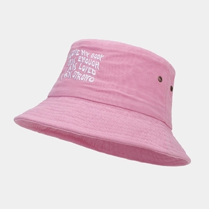 Detailed view of pink cotton bucket hat with white embroidery and metal eyelets