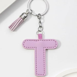 Close-up of purple PU leather letter T keychain with tassel and silver ring