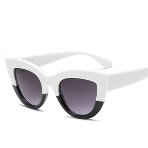 Retro cat-eye sunglasses with trendy black and white frame and dark lenses
