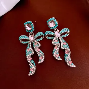 Vintage style bow drop earrings with turquoise beads and pink crystals on silver base