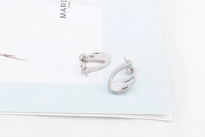 Detailed view of silver swan-shaped stud earrings with brushed metallic texture finish