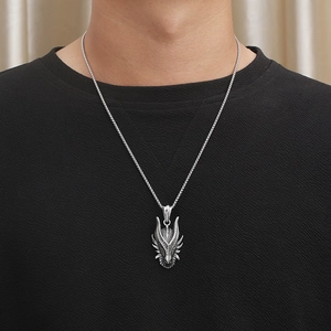 Close-up of a men's punk dragon head pendant with box chain on a male model