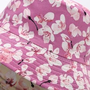 Close-up of pink cherry blossom pattern and reinforced stitching on a bucket hat