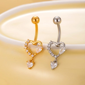 Macro shot of gold and silver heart-shaped navel rings with micro-pave cubic zirconia
