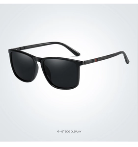45-degree side view of black polarized sunglasses with red and green striped temples