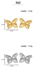 Detailed view of gold and silver butterfly earrings with size dimensions and weight display