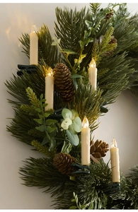 Close-up of Christmas wreath featuring green PE pine needles, cones and LED clip-on candles