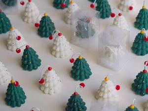 Mini Christmas tree candles in green and white colors with festive gift packaging