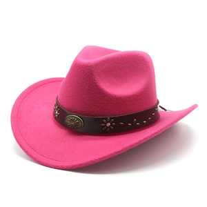 Detail of fuchsia felt cowboy hat featuring vintage metal studs and sun pattern buckle