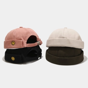 Cotton miki hats with smiley face embroidery in pink, black, cream, and dark green