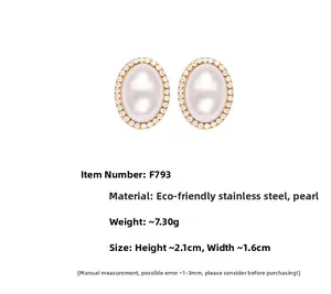Detail view of oval shell pearl earrings with zircon inlay and golden stainless steel base